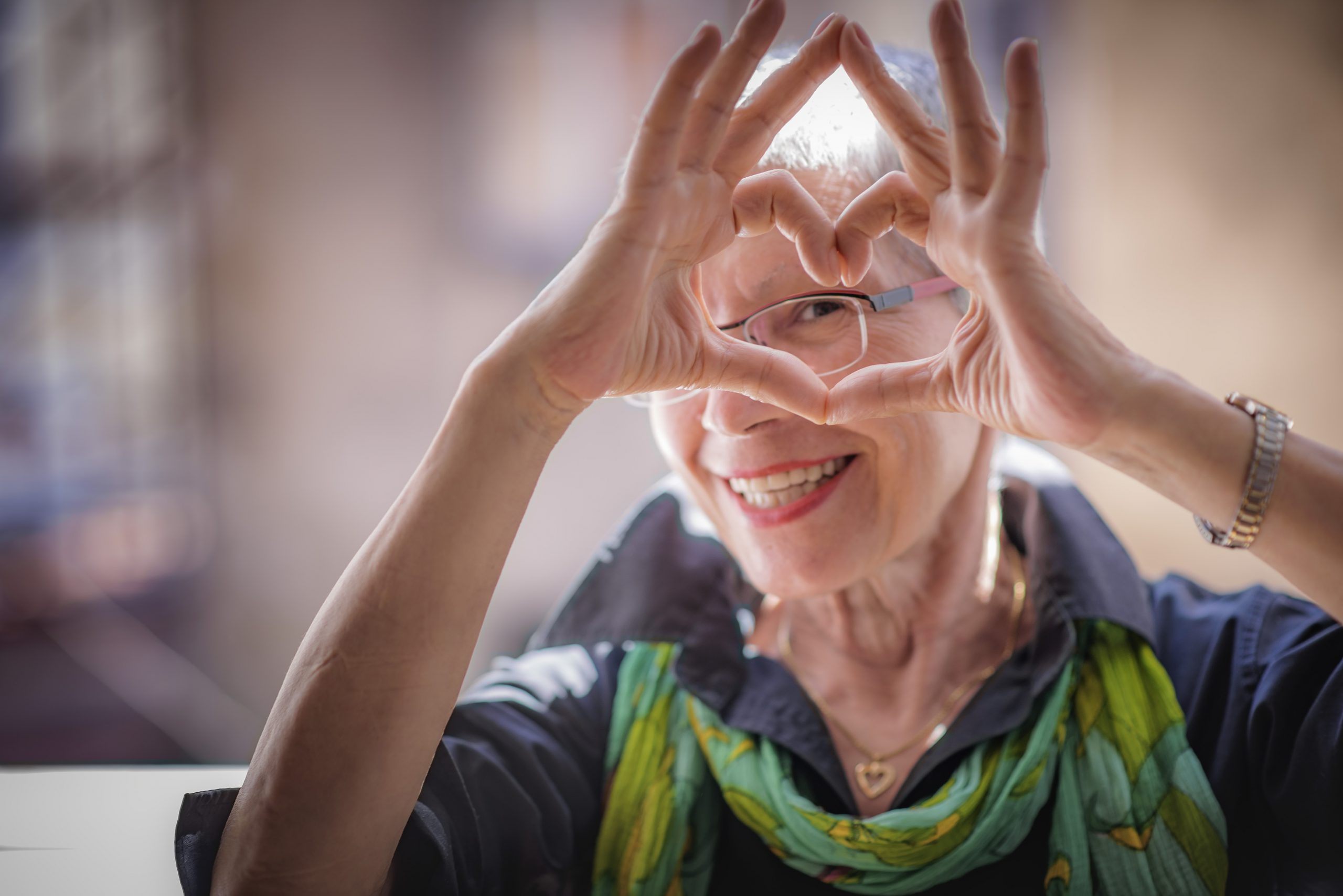 Happy senior making heart hands